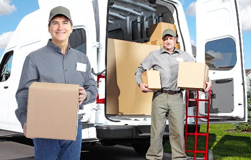 Moving crew unloading household items at a Docklands property